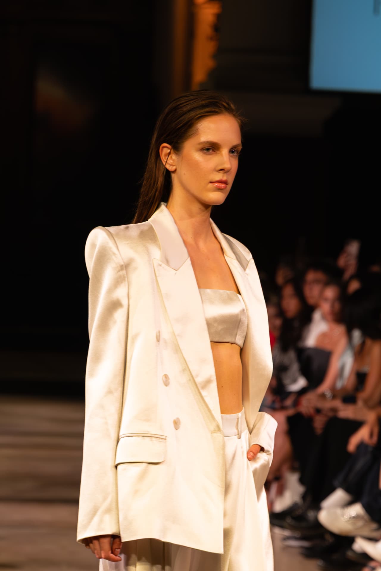 Model in an ivory satin suit with a champagne bandeau