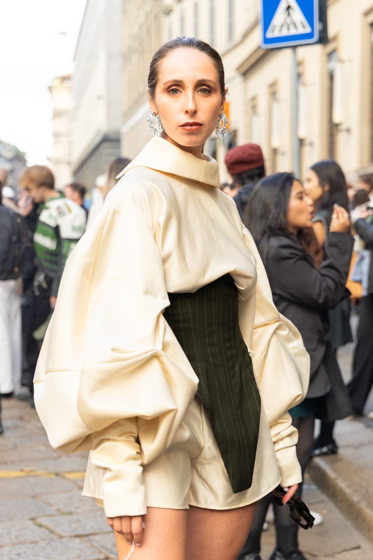 Model in cream leather shirt with dark pinstripe corset