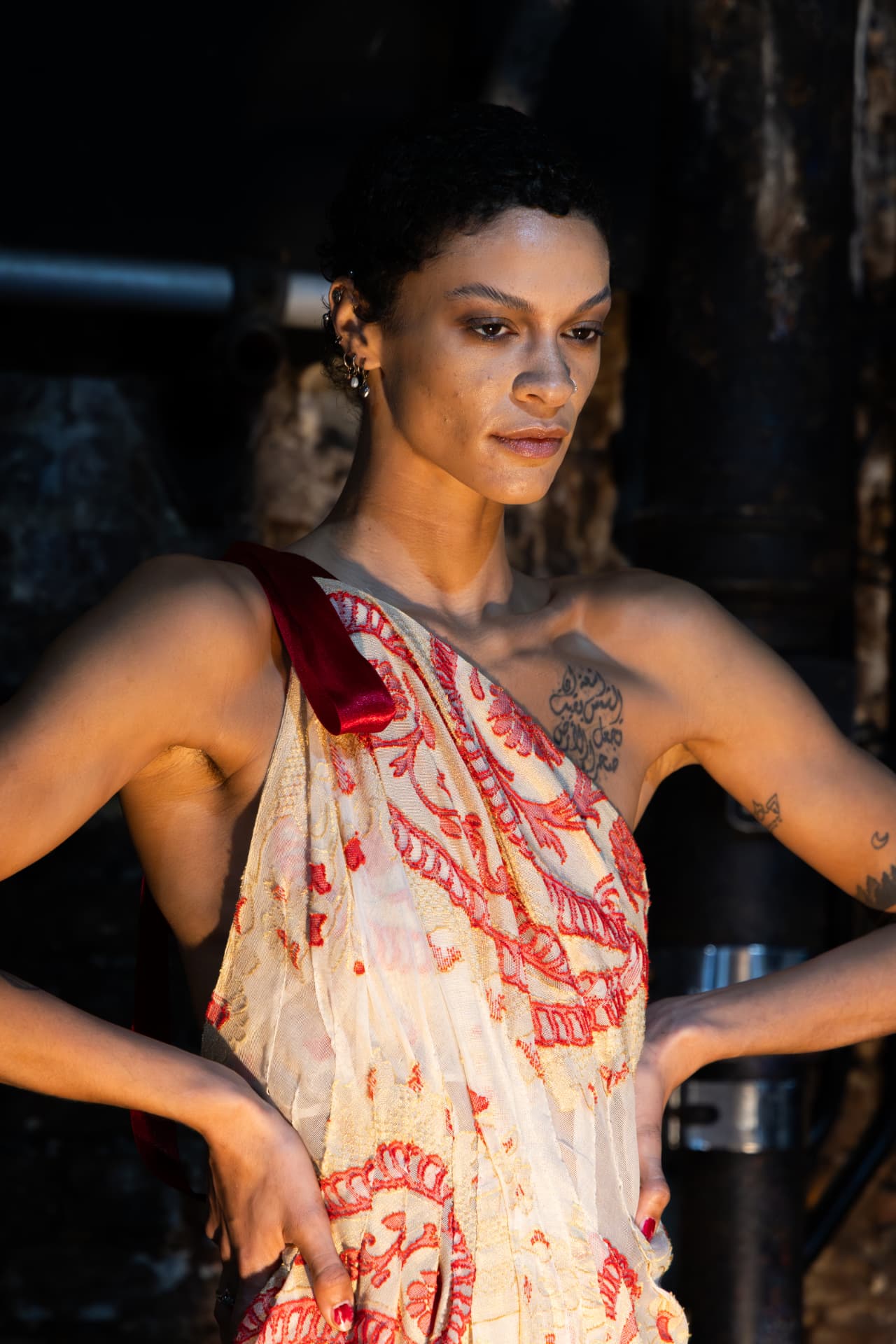 Model in cream and red embroidered one-shoulder dress