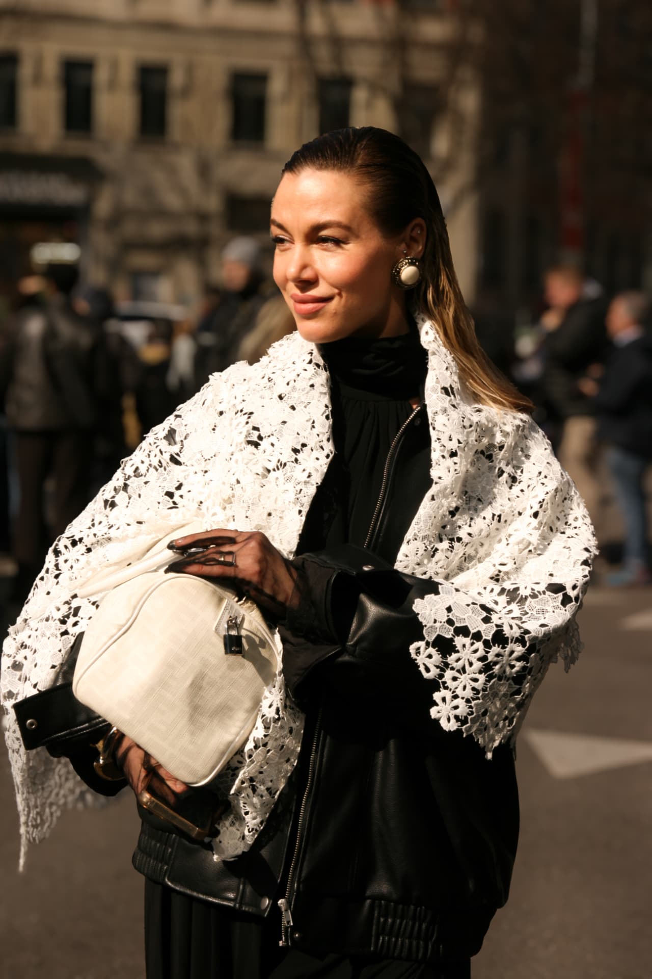 Guest in a white lace shawl over a black leather jacket