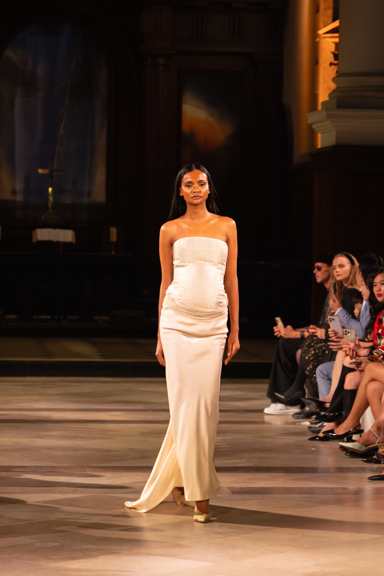 Model in an ivory satin corset gown