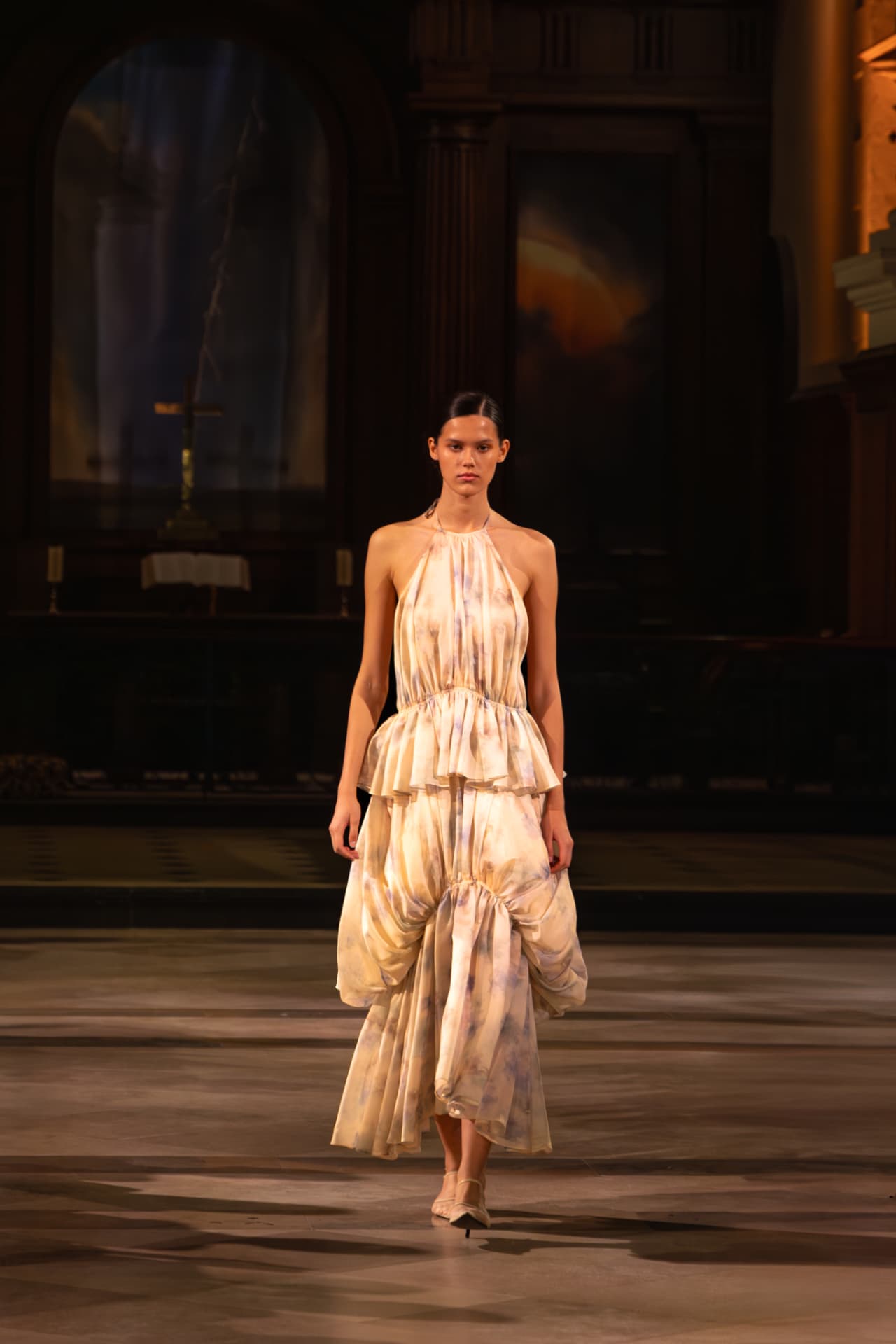 Model in a printed halter dress with ruffled tiers