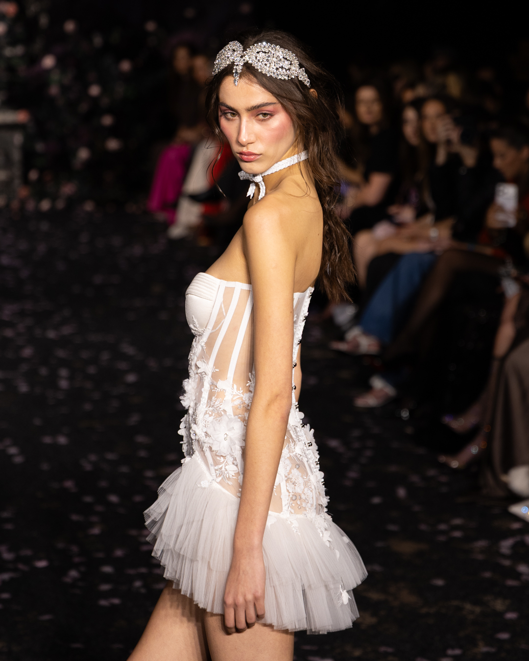 Model in a sheer corset mini dress with ruffled tulle hem