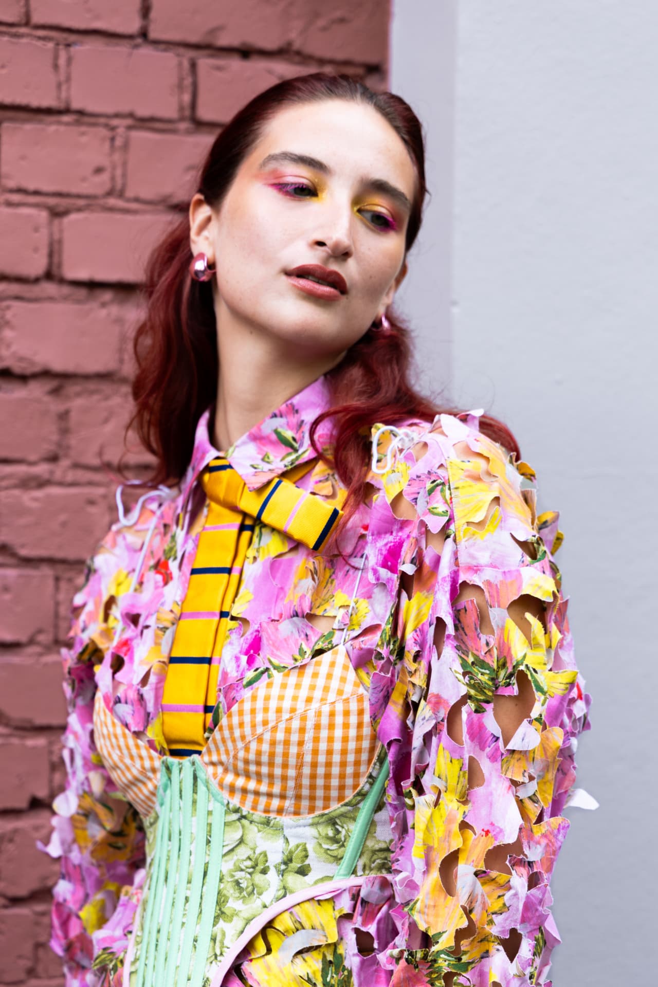 Guest in a cut-out floral shirt with graphic corset