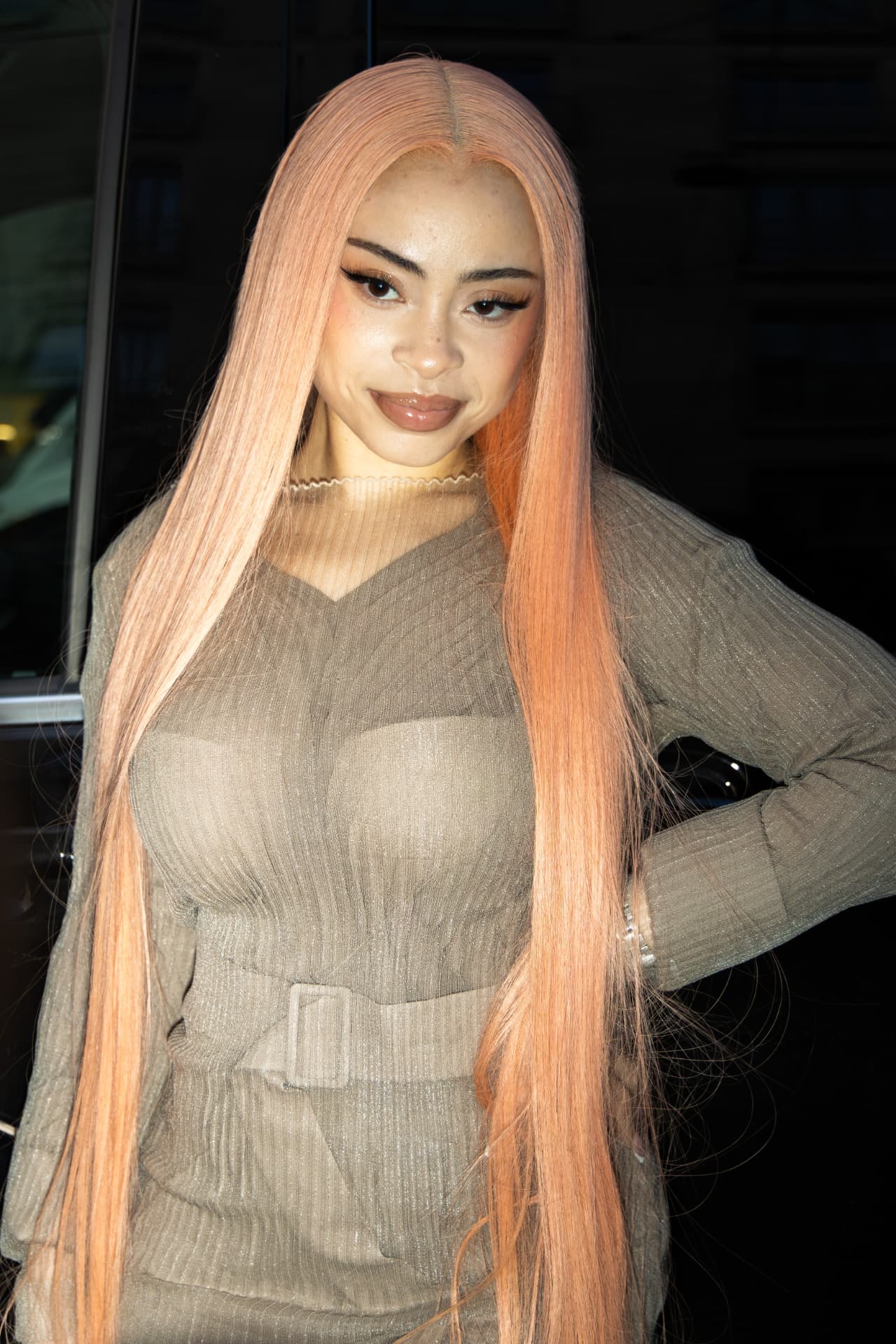 Model with long peach hair in a sheer olive knit set