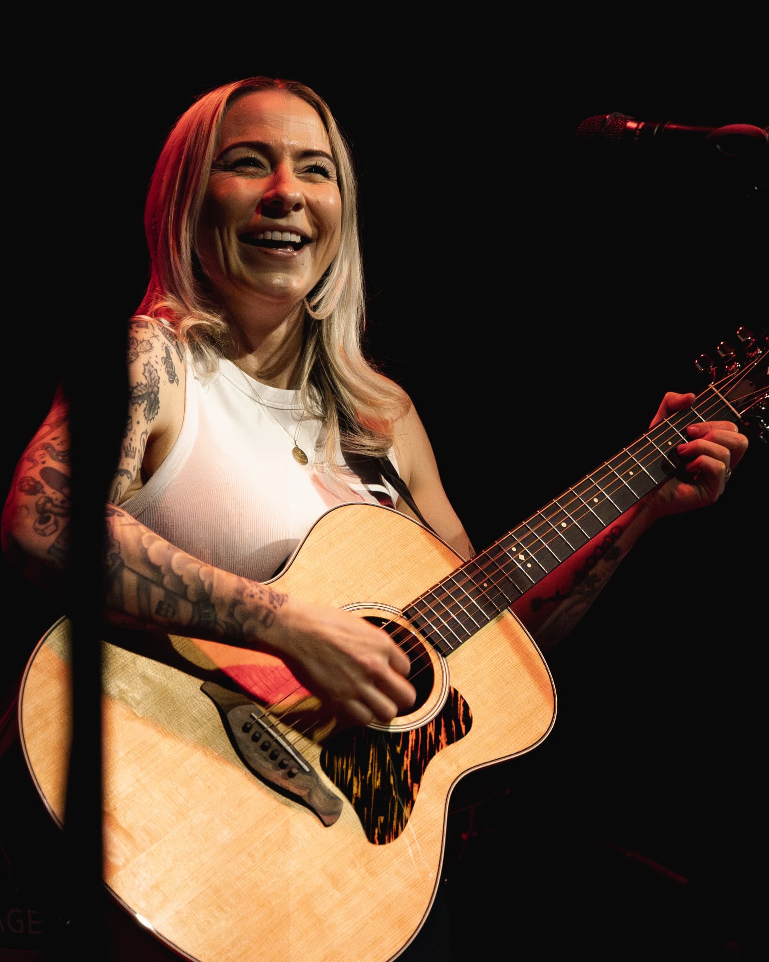 Laughing mid-song with the guitar raised