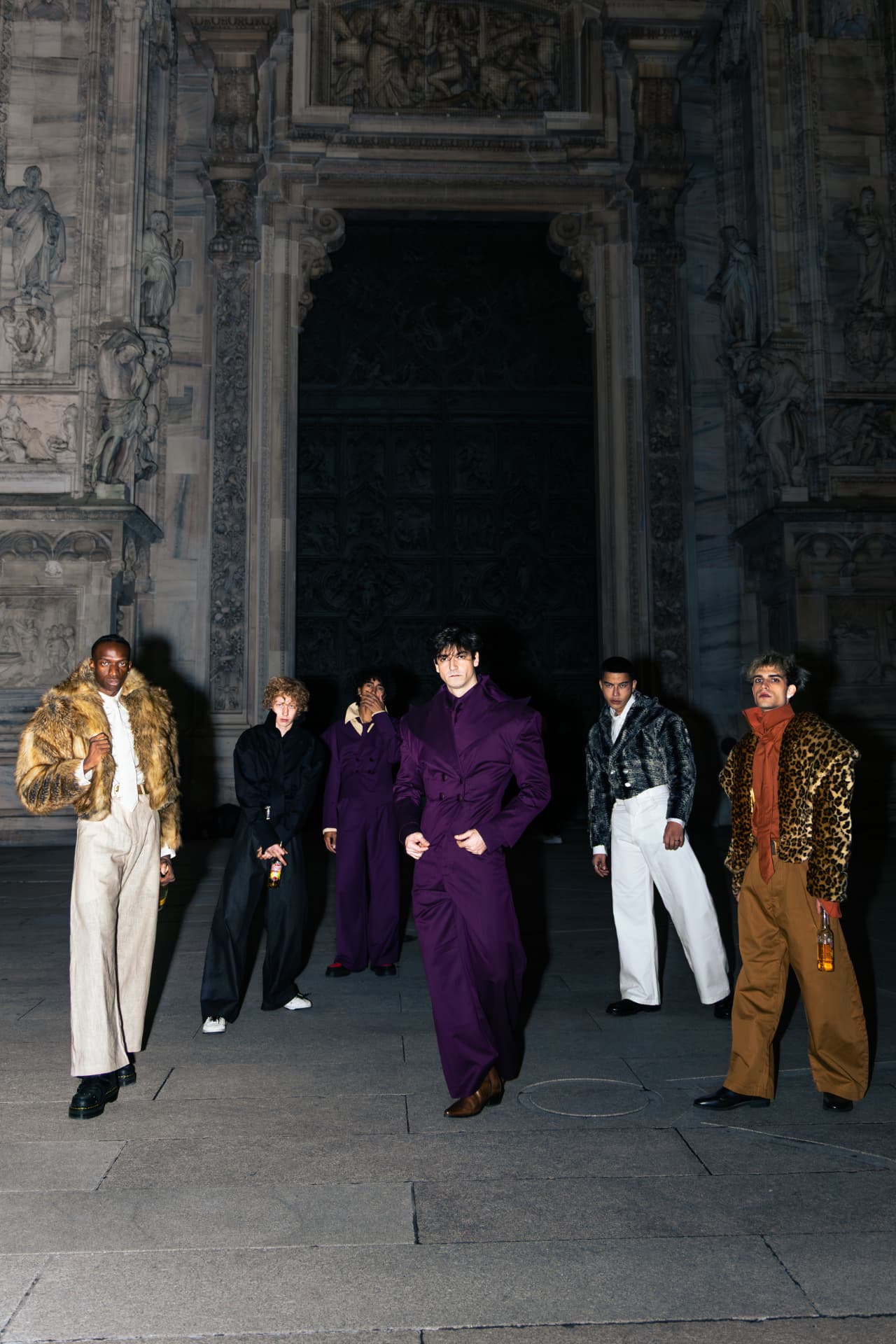 Line of models walking out of the cathedral doorway