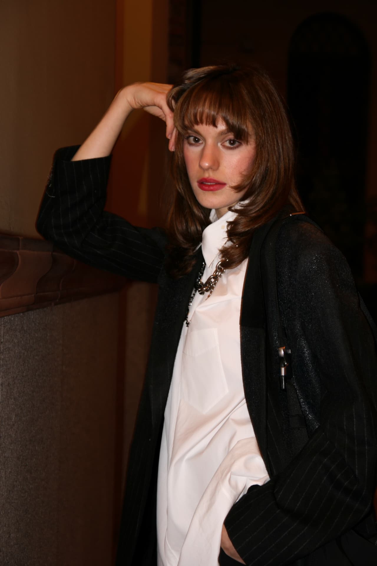Guest in a pinstripe blazer and white shirt indoors