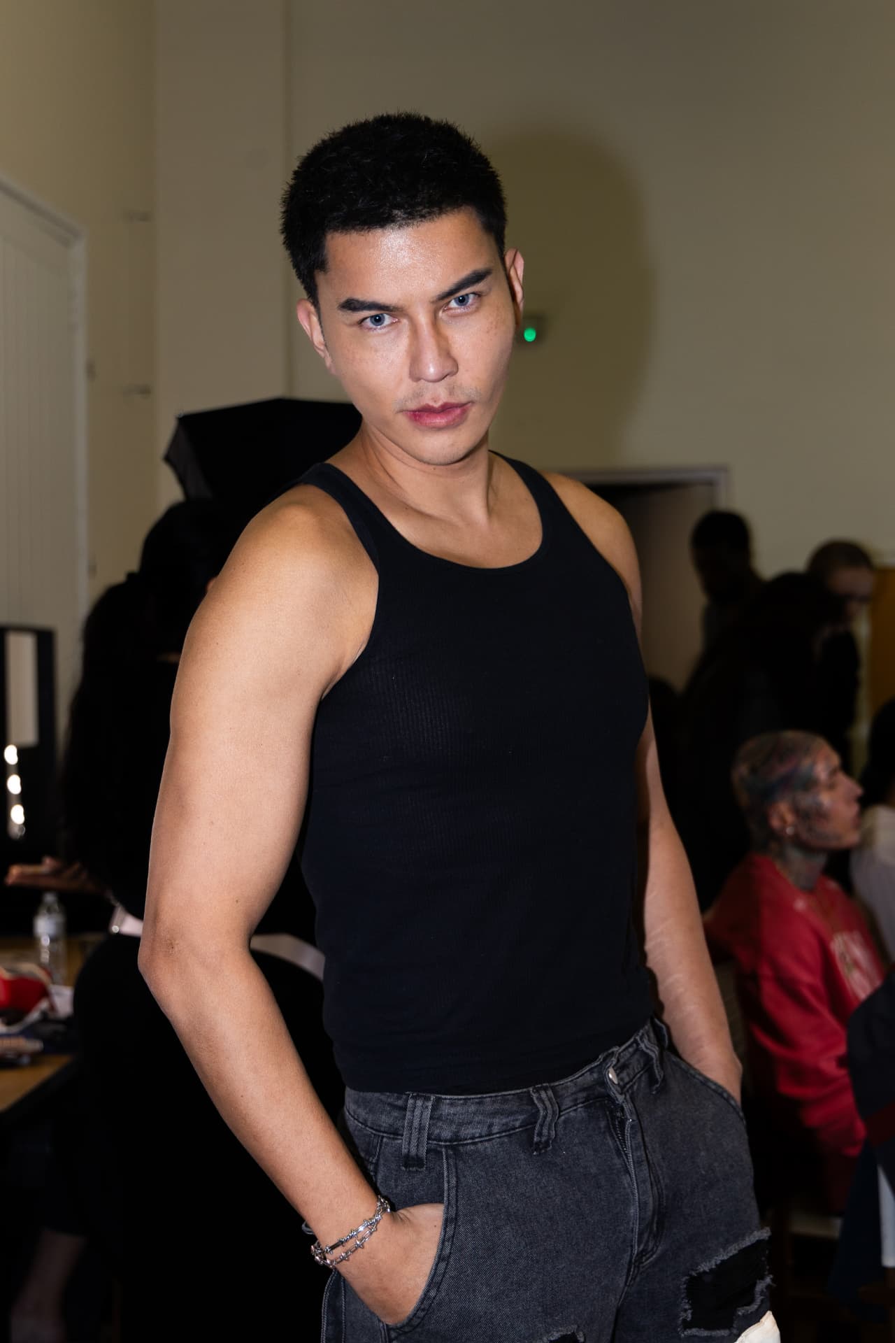 Model in black vest backstage before the show