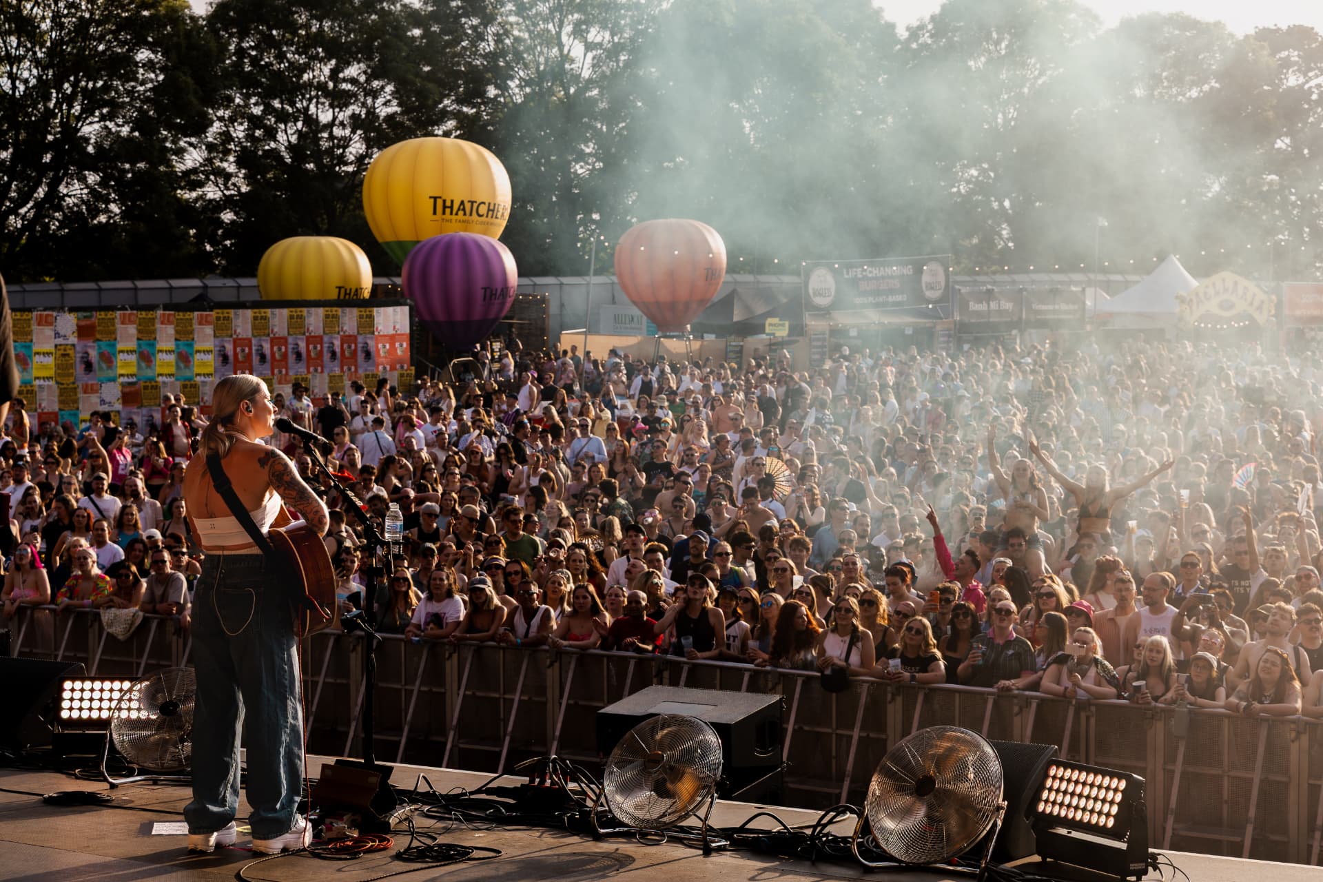 Performing to a packed festival crowd at golden hour