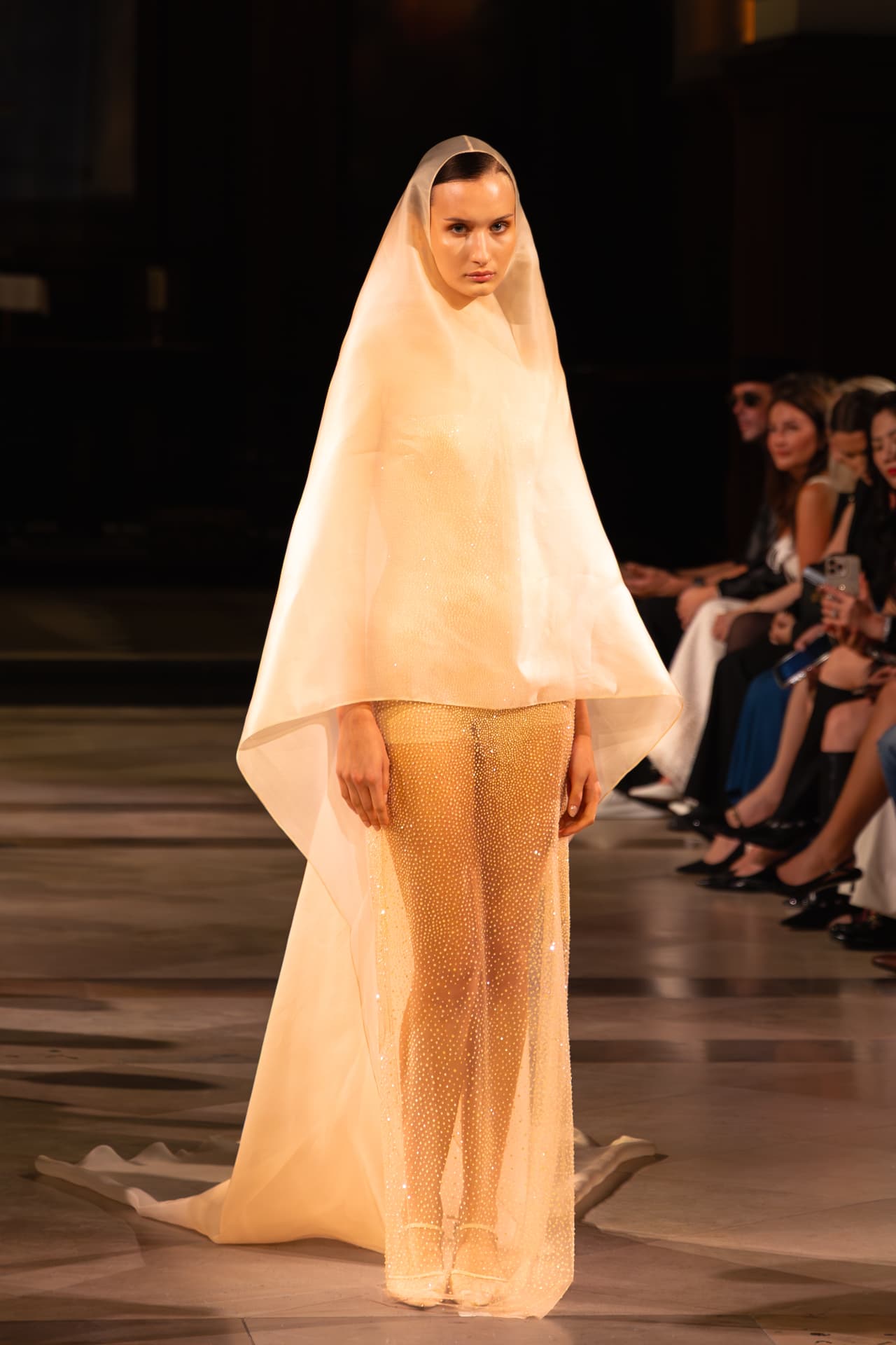 Model in a sheer crystal gown with an organza veil