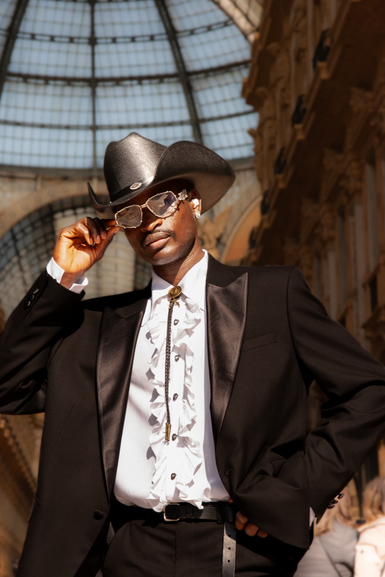 Guest in black tuxedo, ruffled shirt and cowboy hat in the Galleria