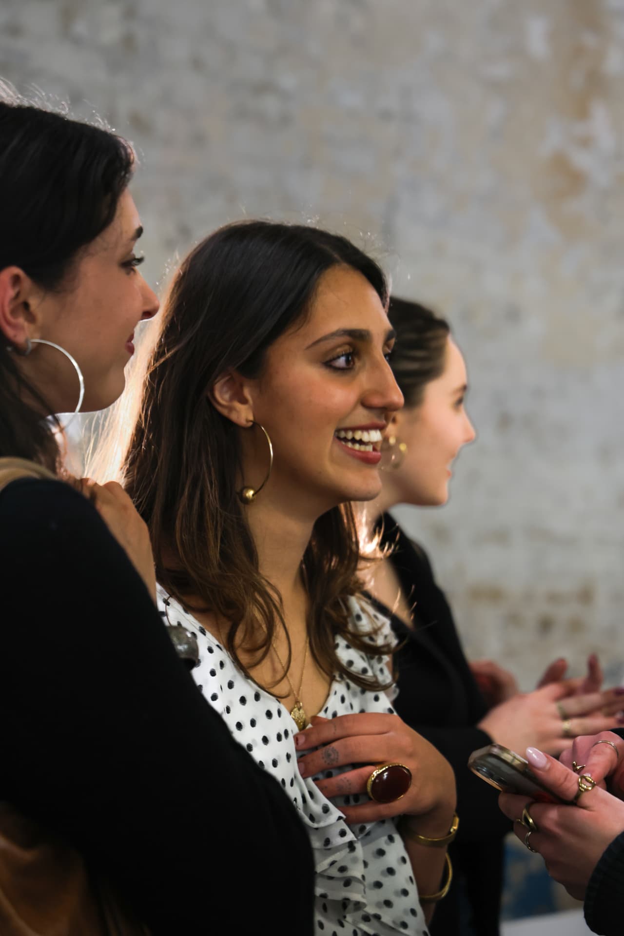 Guests in profile listening at the exhibition opening