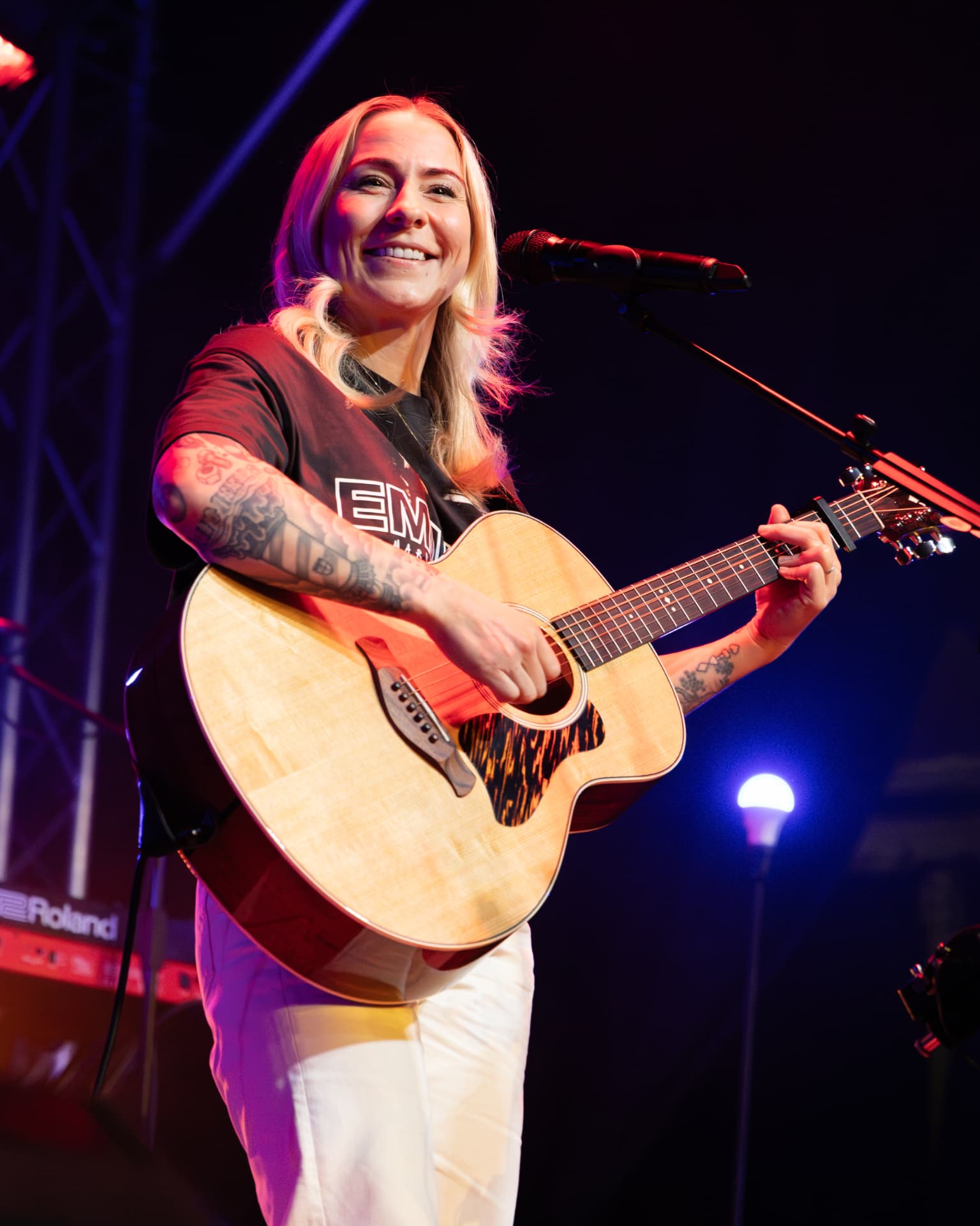 Lucy Spraggan smiling low angle with her guitar