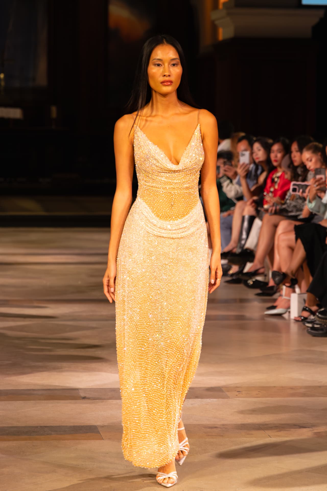 Model in a champagne beaded slip gown