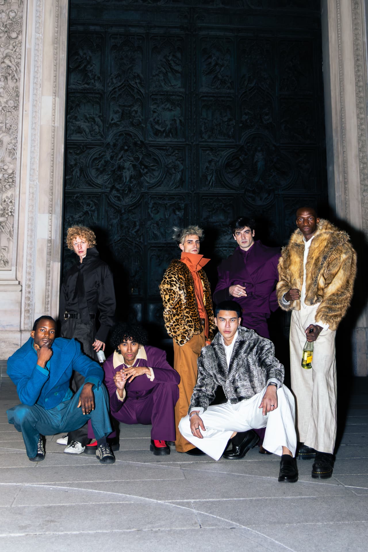Full group portrait in front of the bronze doors