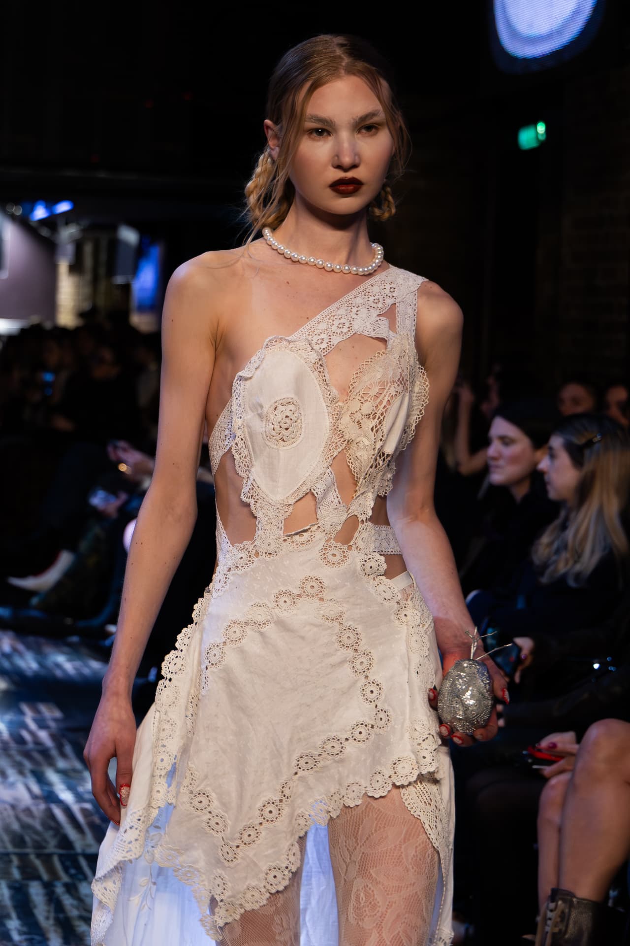 Model in a patchwork lace dress with a pearl choker