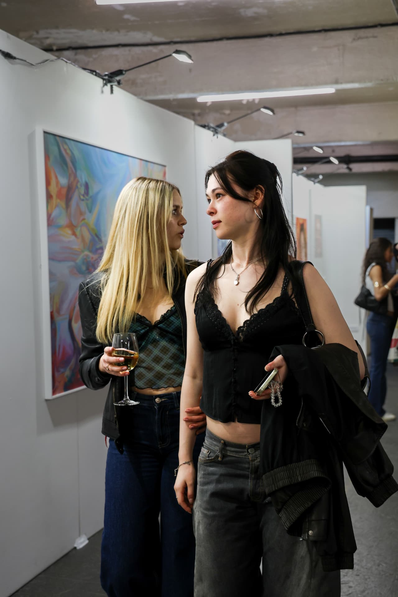 Two visitors talking in the exhibition aisle