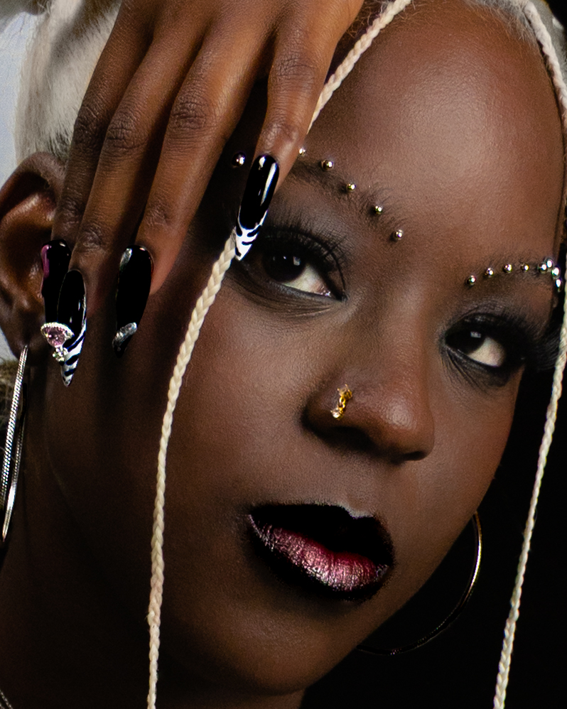 Tight crop of jewelled brows and metallic lips