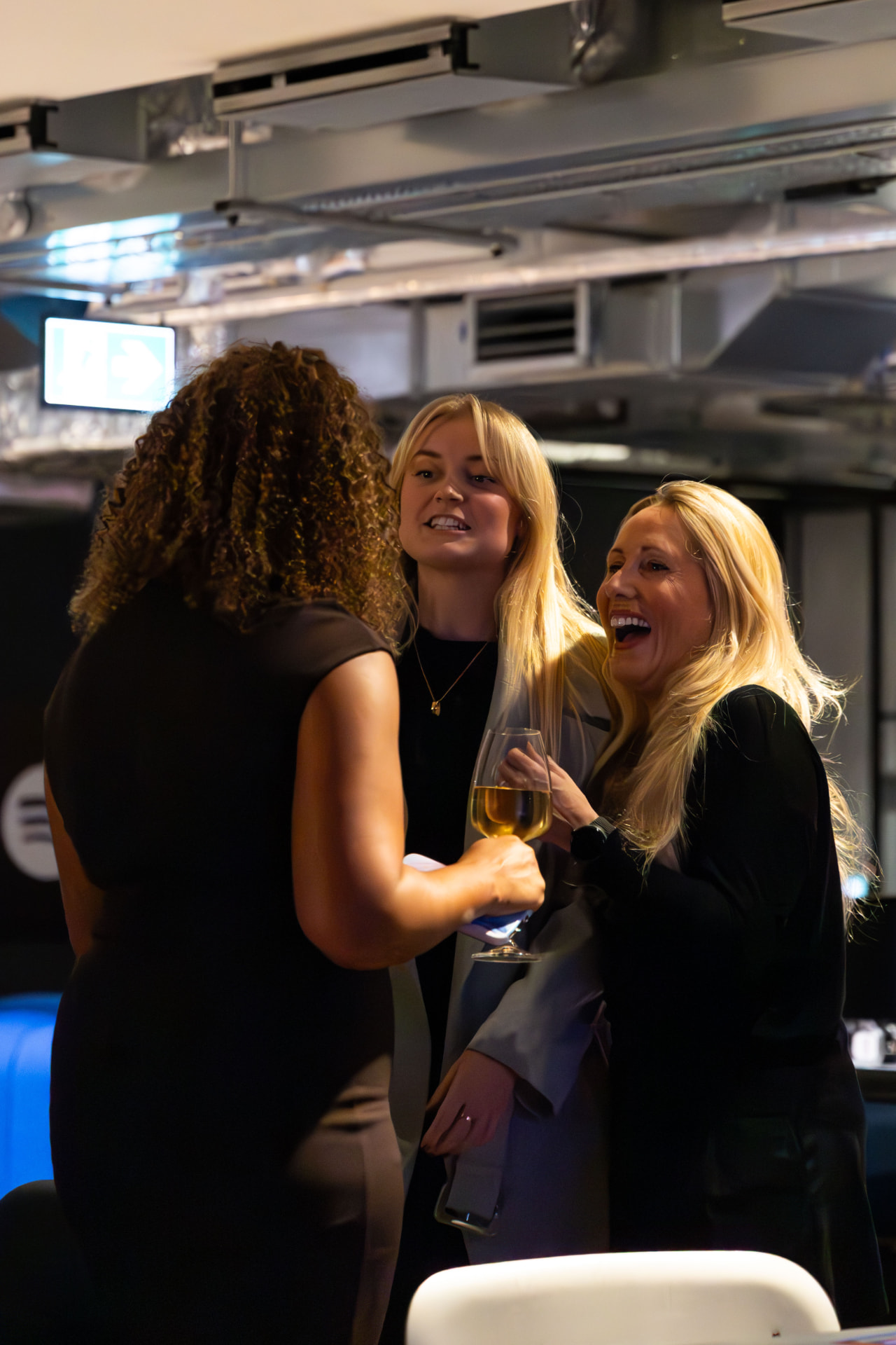 Group of guests laughing together at the drinks reception