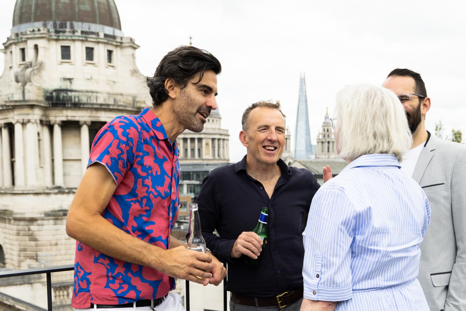 Group laughing on the rooftop with St Paul's behind